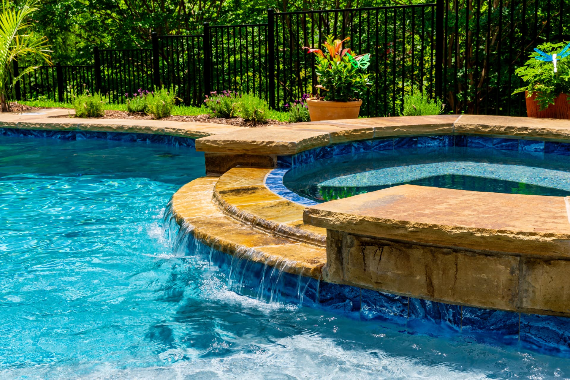 Freeform with spillover spa and stone coping