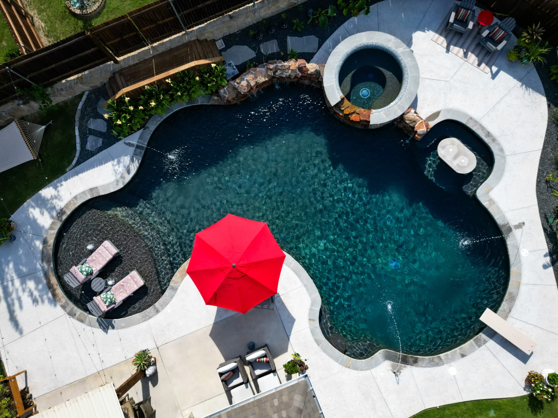 Freeform with dark plaster finish, raised spa and diving board
