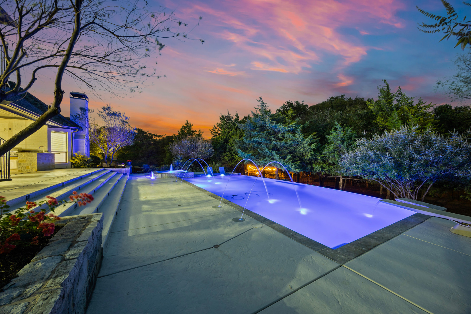 RiverMist pool with laminar water arcs and negative edge at sunset