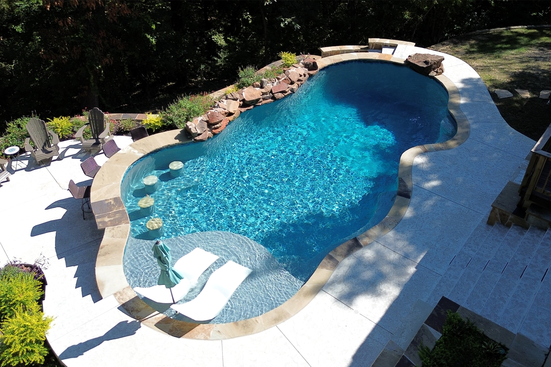 Aerial view of a RiverMist freeform pool ready for a summer gathering