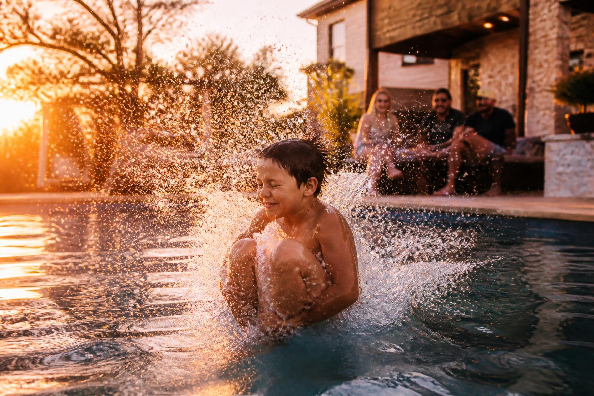 Family enjoying a RiverMist backyard pool